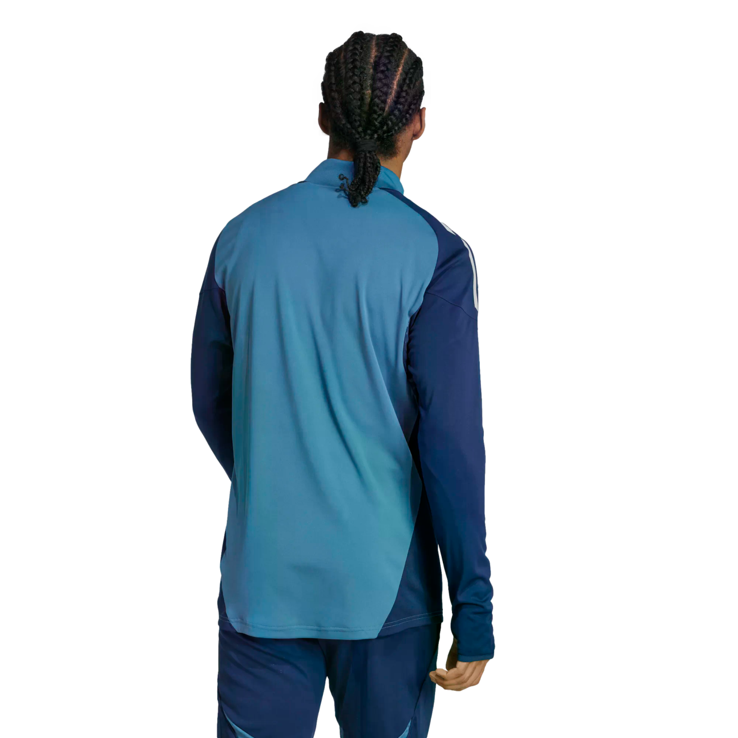 Rear view of a person with braided hair wearing a two-tone blue athletic long-sleeve top and matching pants against a solid black background.