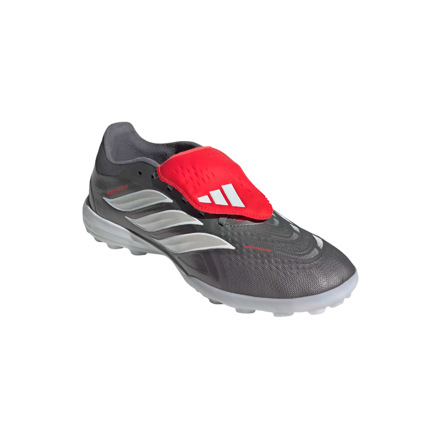 Adidas Predator turf soccer shoe in dark gray with white three-stripes and a red fold-over tongue featuring the Adidas logo.
