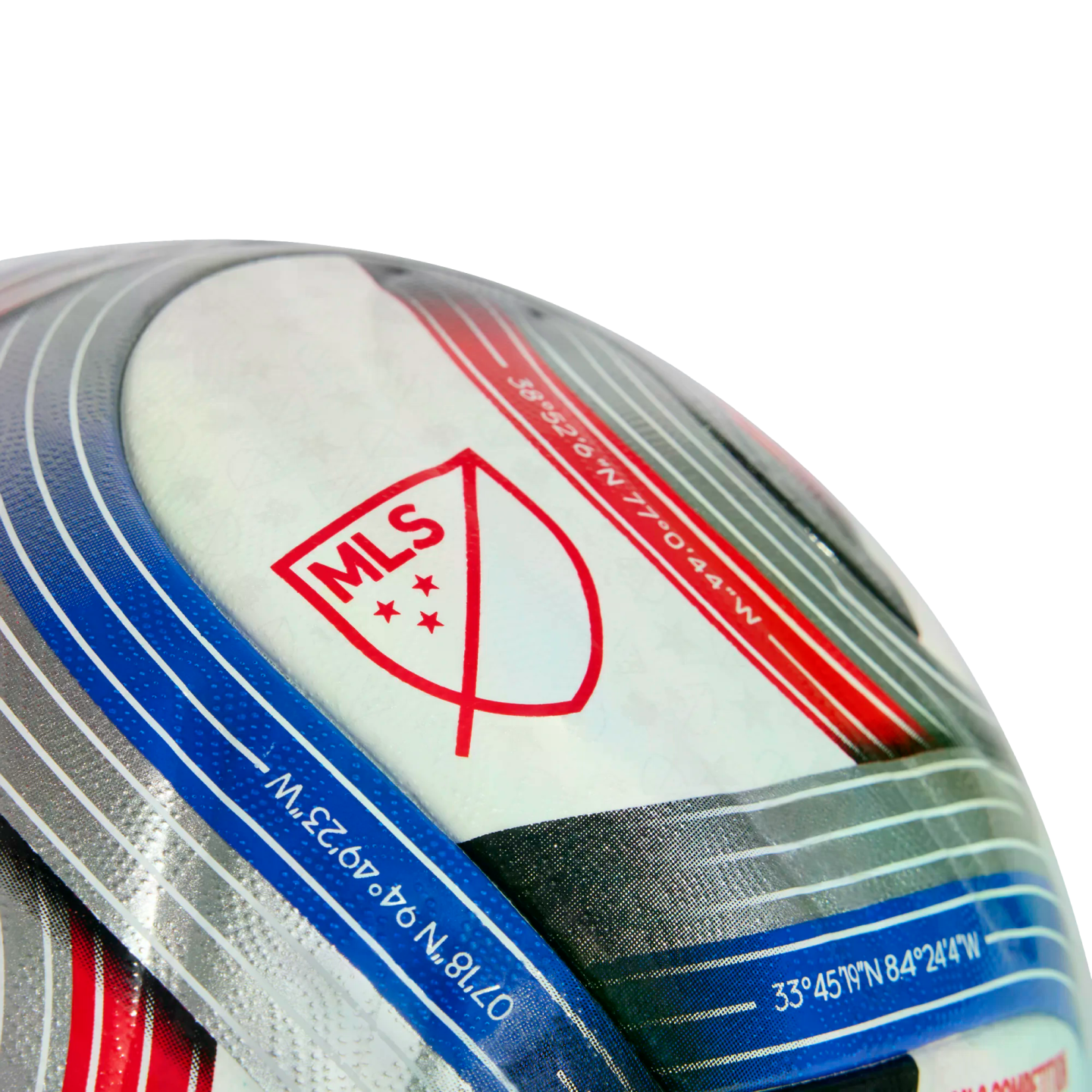 Close-up of a textured soccer ball featuring the red MLS logo and geographic coordinates printed on blue and red stripes.