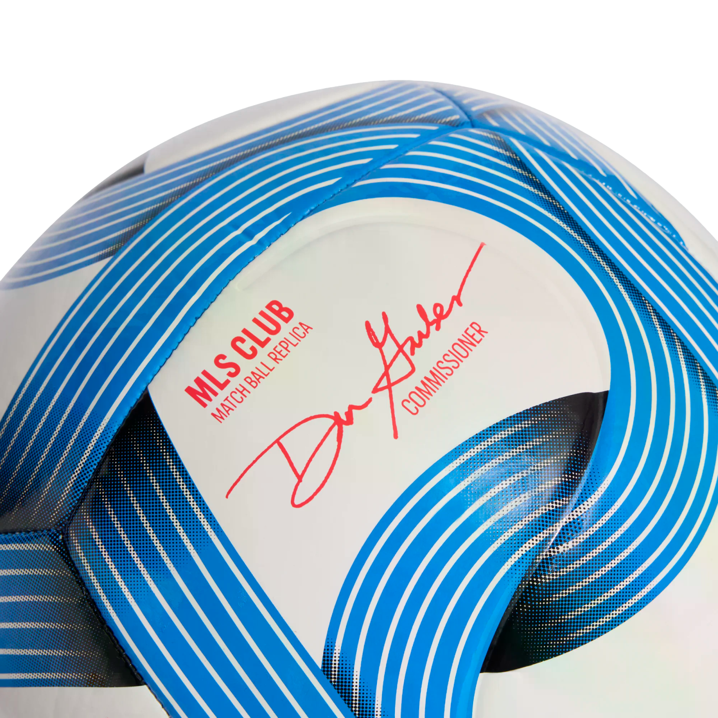 Close-up of an MLS soccer ball replica with blue curved graphics and a red signature from Commissioner Don Garber.