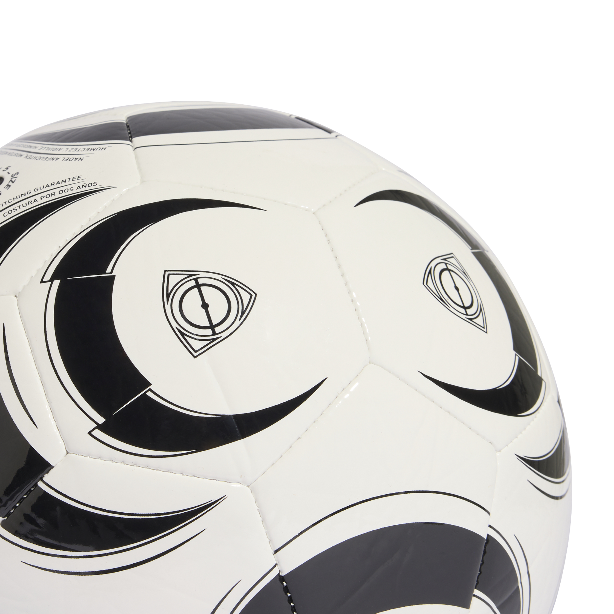 A close-up of a white soccer ball with black decorative swooshes and a triangular logo, set against a solid black background.