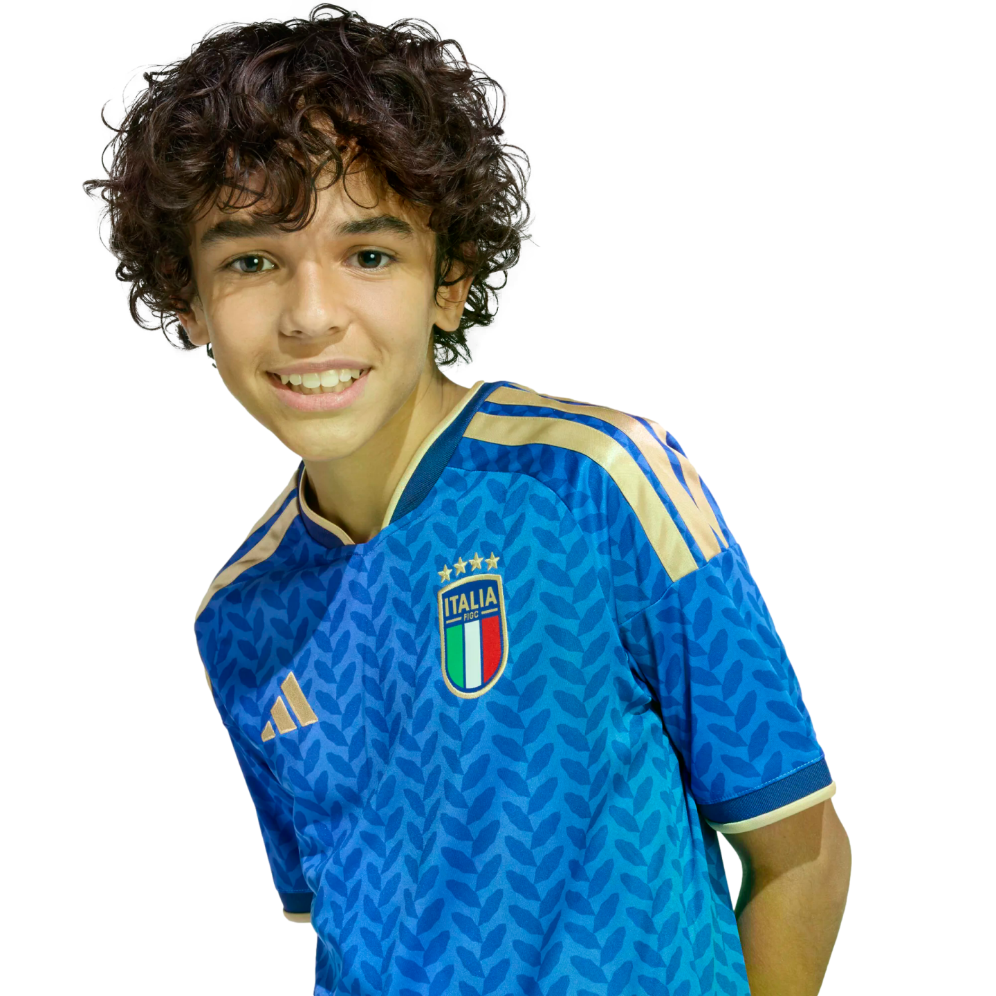 Smiling boy with curly brown hair wearing a blue Italy soccer jersey against a black background.