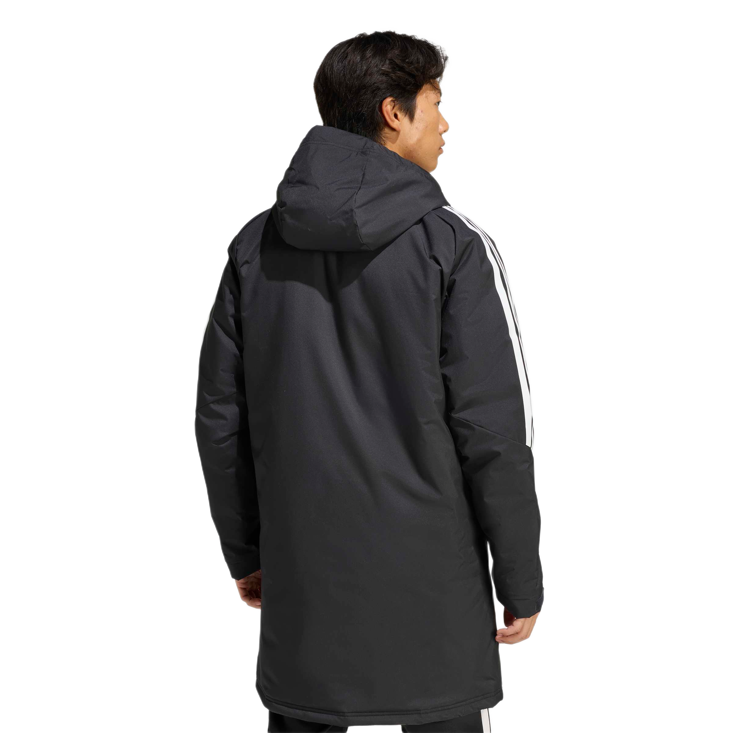 Rear view of a man in a long black hooded parka with white stripes on the sleeves, against a light gray background.