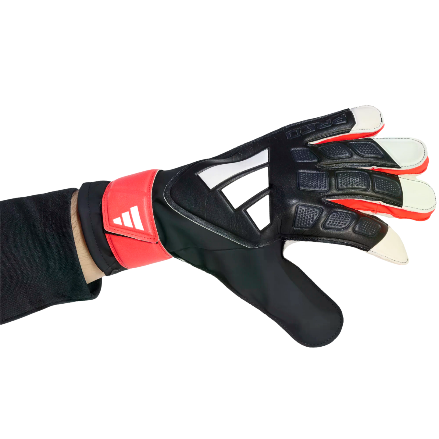 Hand wearing a black, red, and white Adidas goalkeeper glove with a textured grip, positioned against a solid black background.