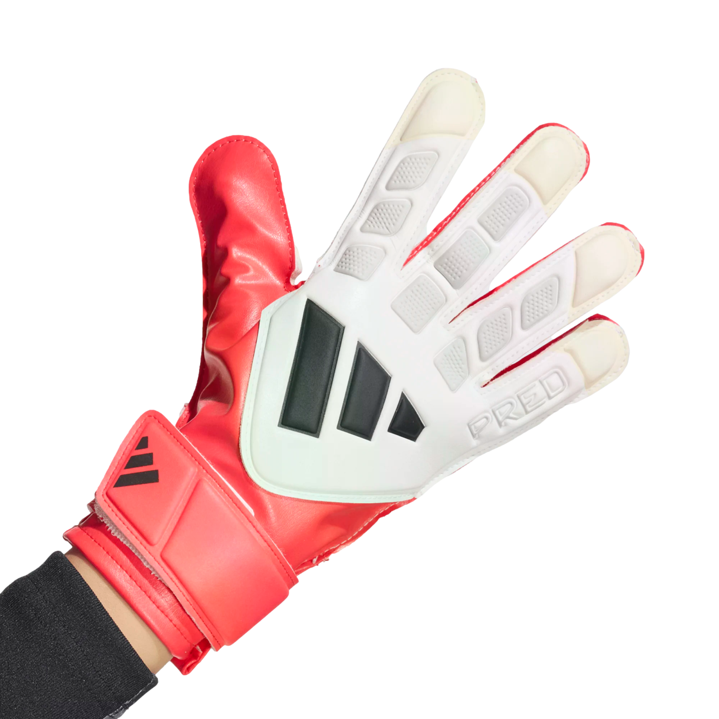 A hand wearing a red and white Adidas Predator goalkeeper glove with black stripes against a solid black background.