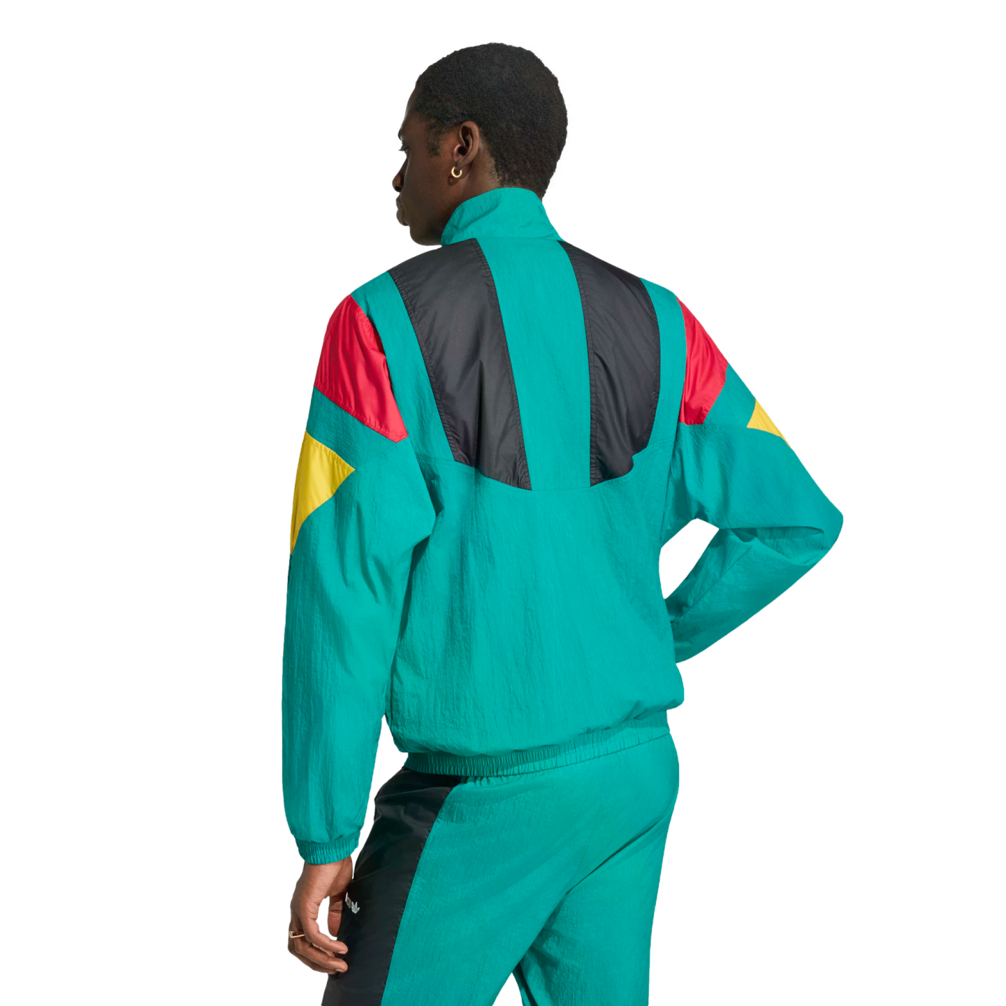 A person from the back wearing a teal tracksuit with red, yellow, and black color-block patterns, against a white background.