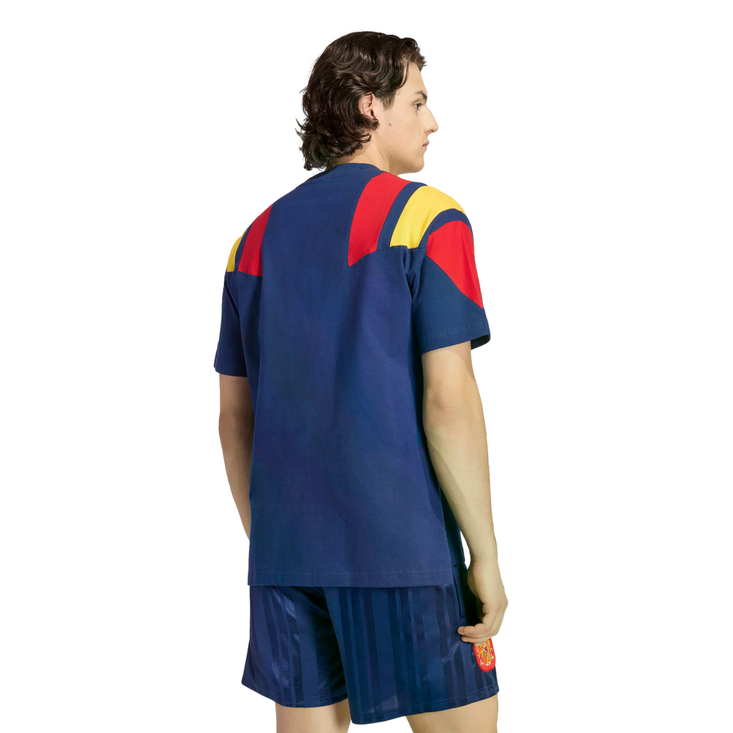 Back view of a person wearing a blue soccer kit with red and yellow shoulder details against a white background.
