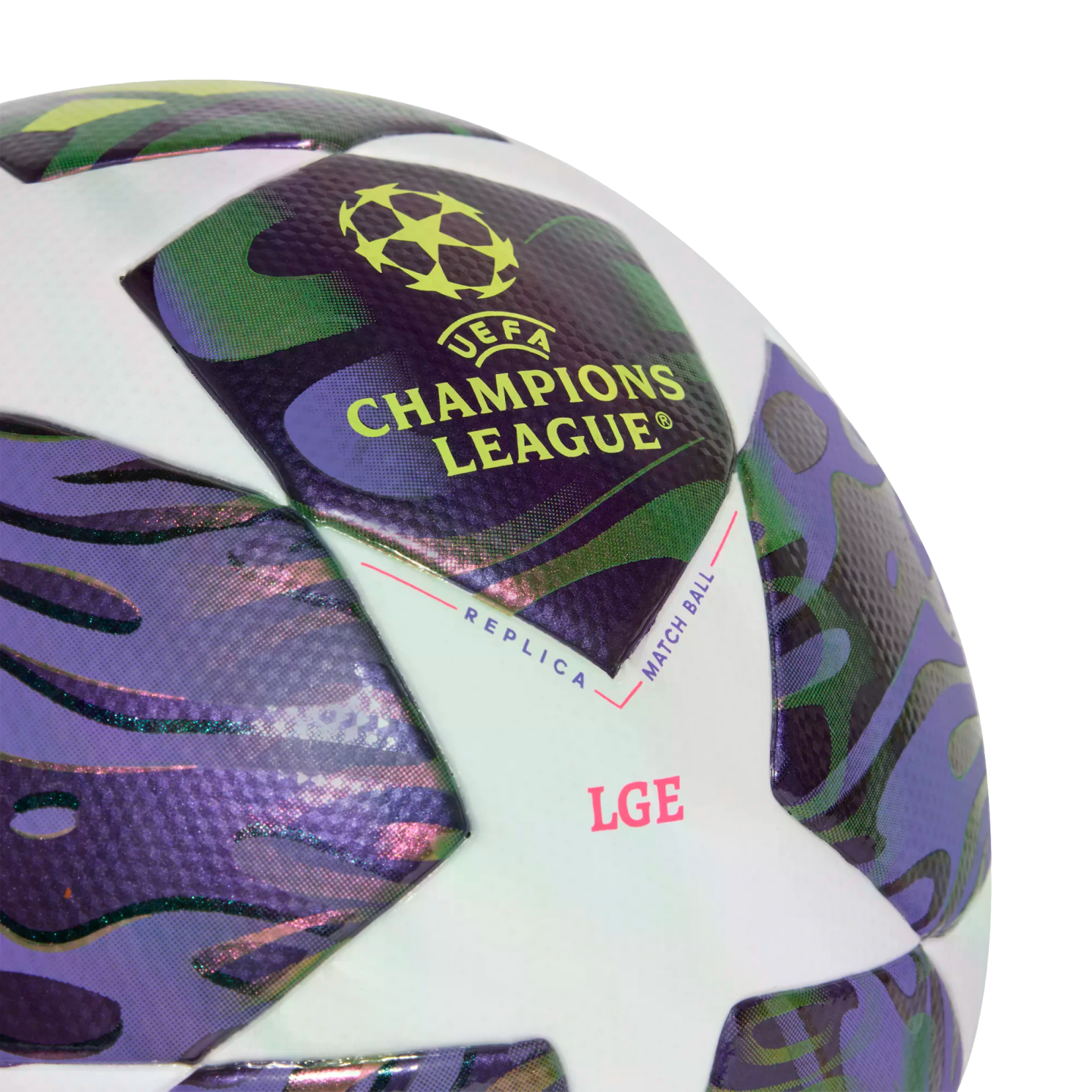Close-up of a UEFA Champions League replica match soccer ball with purple and green patterned star panels.