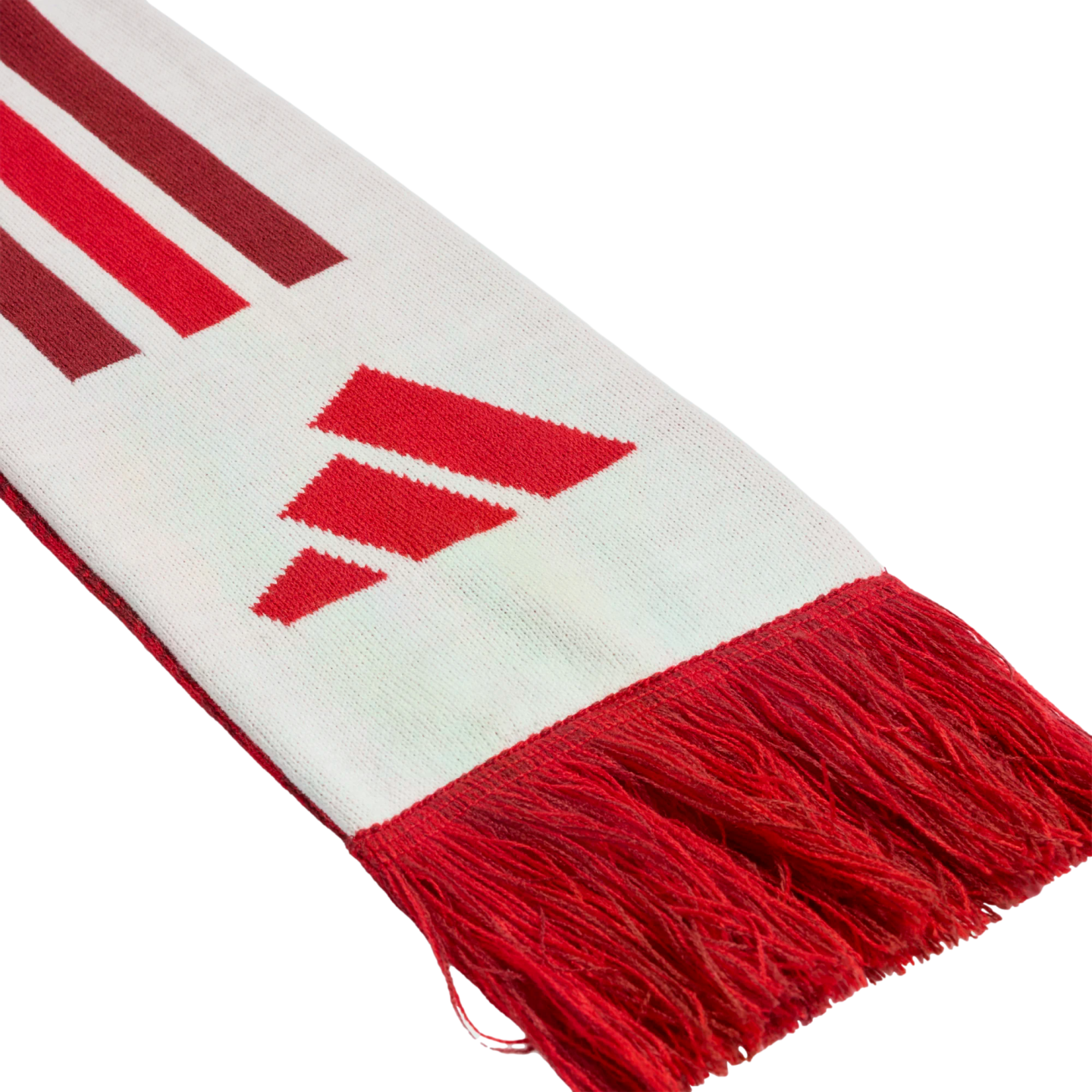 Close-up of a white knitted scarf with red fringe, featuring the red Adidas three-bar logo and diagonal red and maroon stripes.