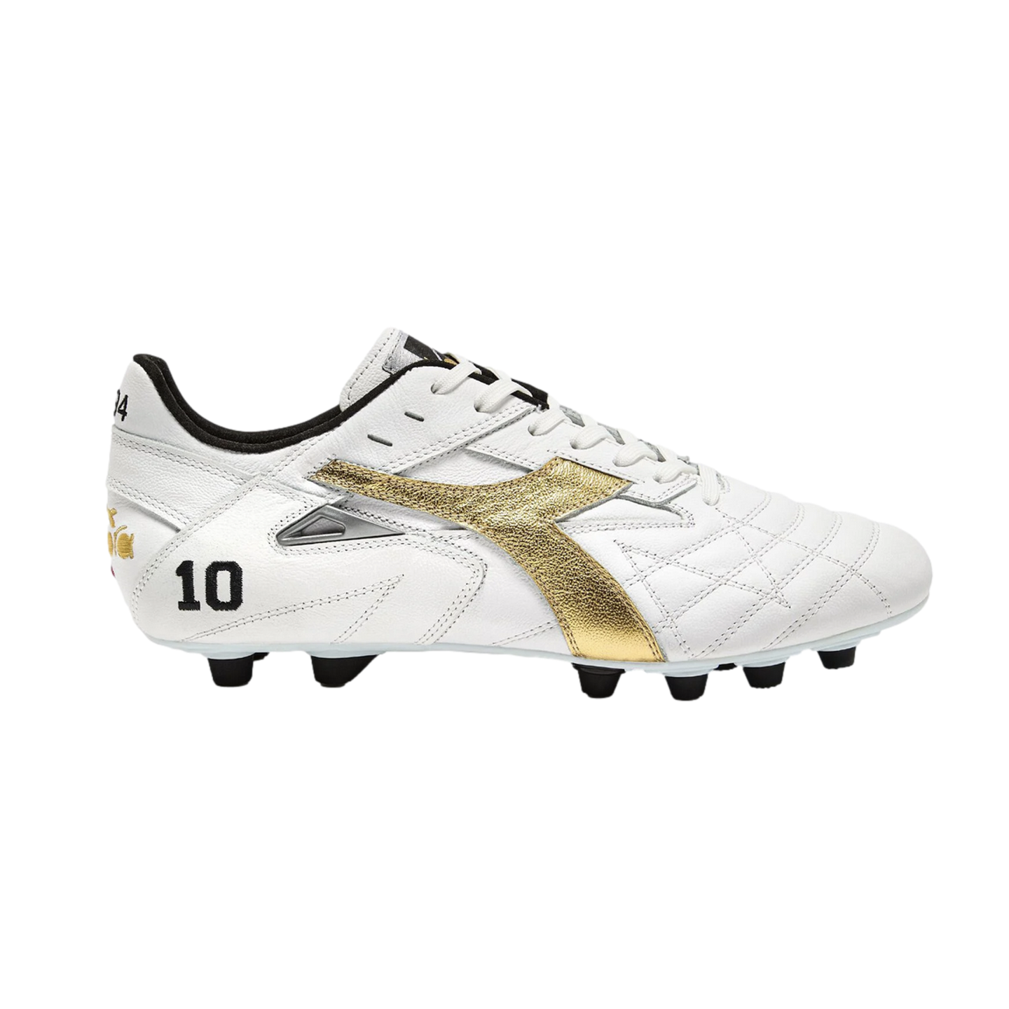 Profile of a white Diadora soccer cleat with a metallic gold logo and the number 10 on the heel. It has white laces and black studs, set against a solid black background.