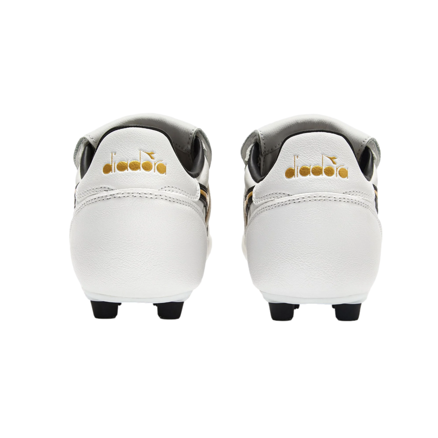 Rear view of white Diadora soccer cleats with gold logos on the heels, set against a solid black background.