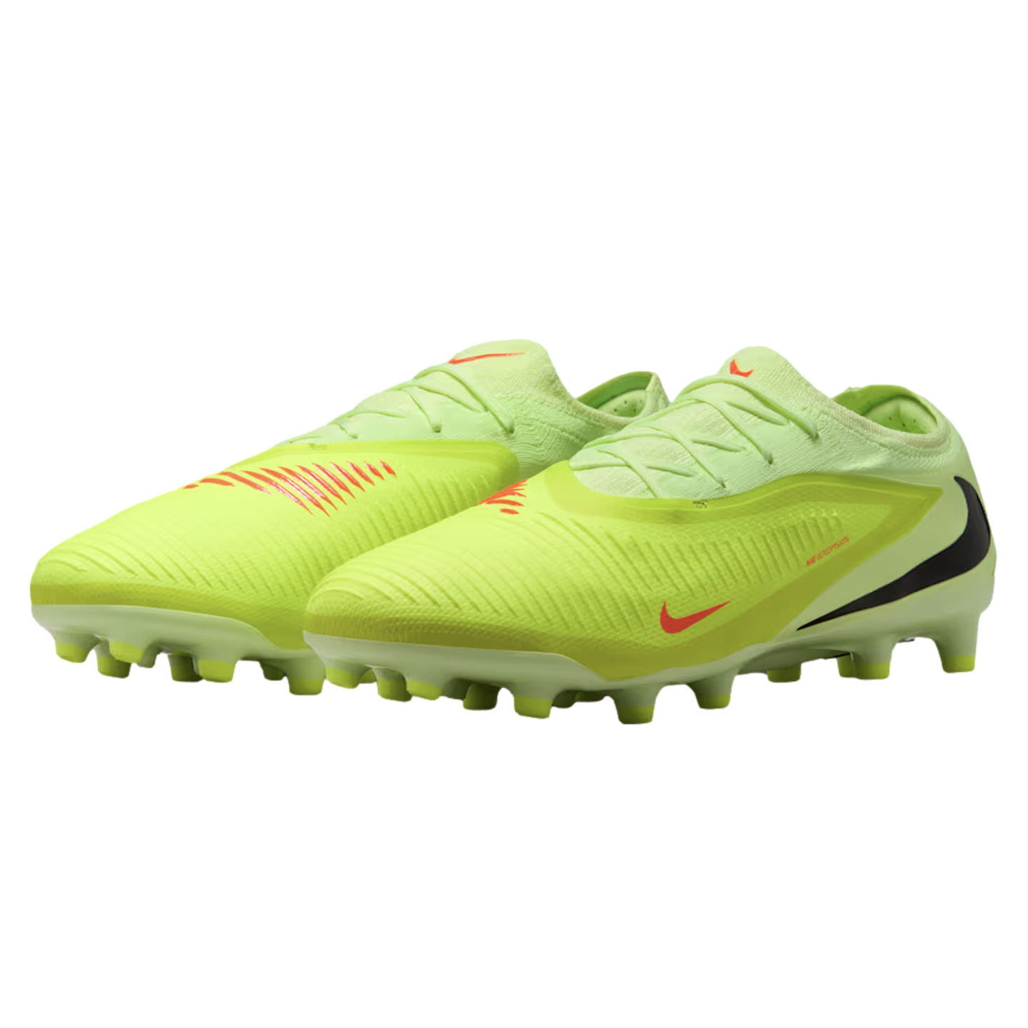 A pair of neon yellow Nike soccer cleats with orange and black swooshes, shown against a black background.