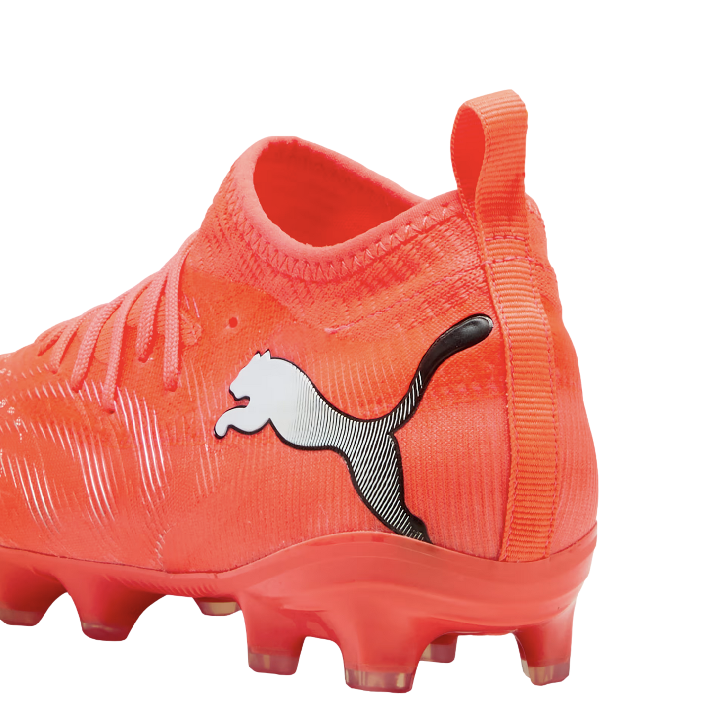 Close-up of a bright orange Puma soccer cleat with a sock-like collar and white logo against a black background.