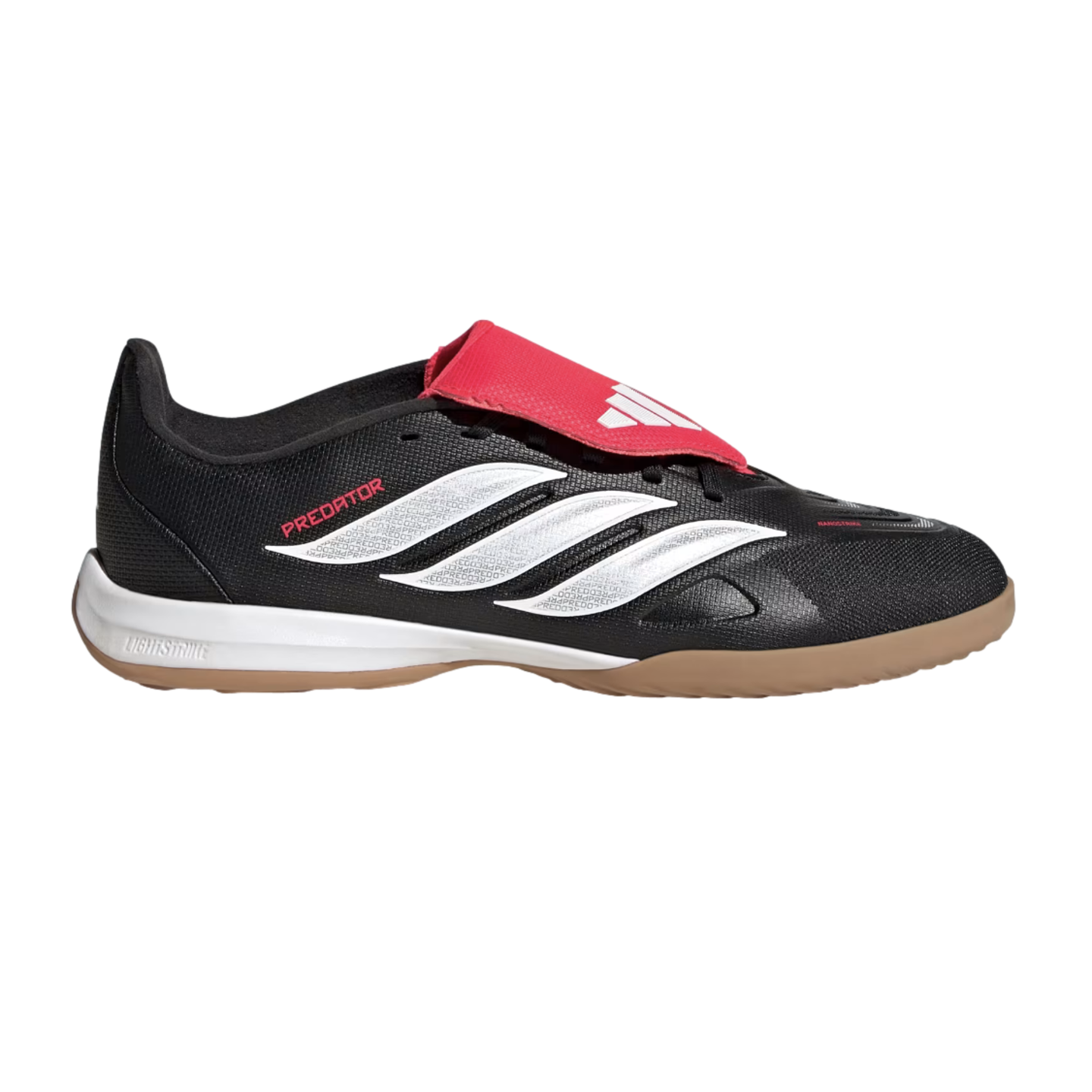 Profile view of an Adidas Predator indoor soccer shoe featuring a black upper, white three-stripes, red fold-over tongue, and gum rubber sole against a black background.