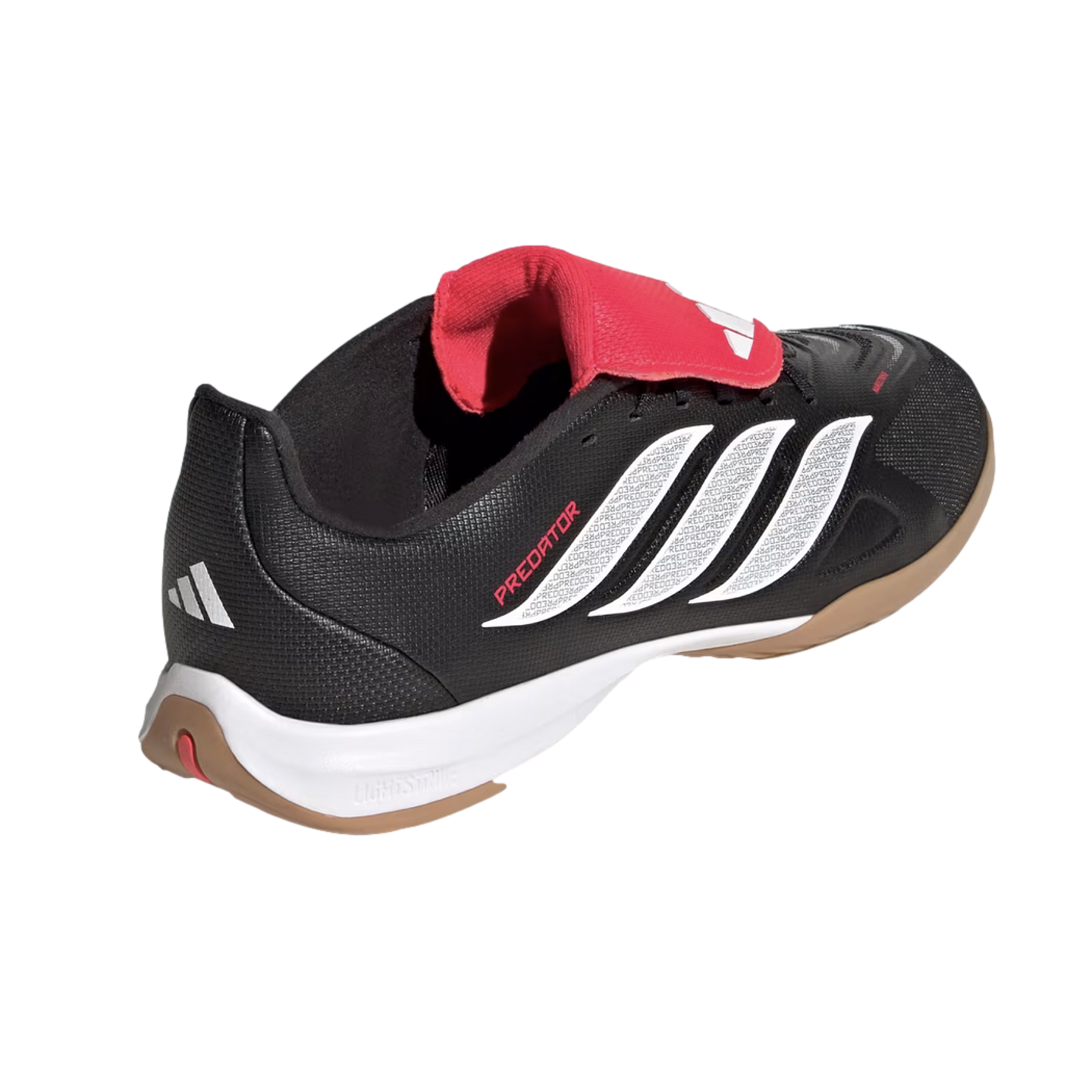 Rear-side view of a black Adidas Predator soccer shoe with white stripes, red tongue, and gum sole, set against a black background.