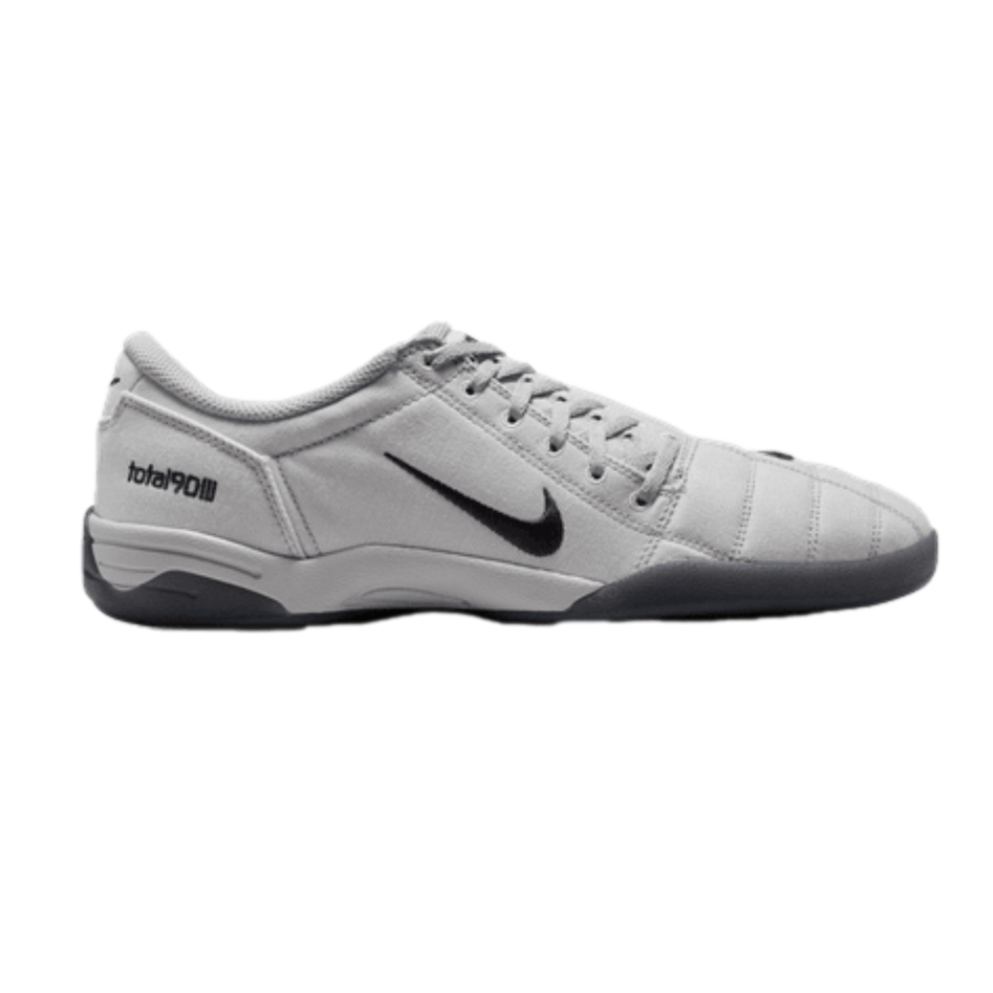 Profile of a light grey Nike Total 90 III indoor soccer shoe featuring a black swoosh and a dark grey sole.